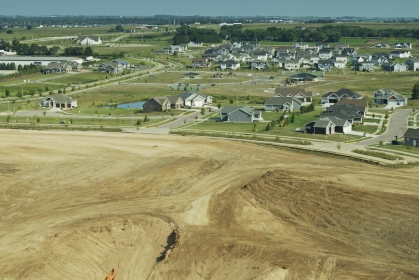 Professional land grading by HB Land Services β build-ready site pad near a residential development